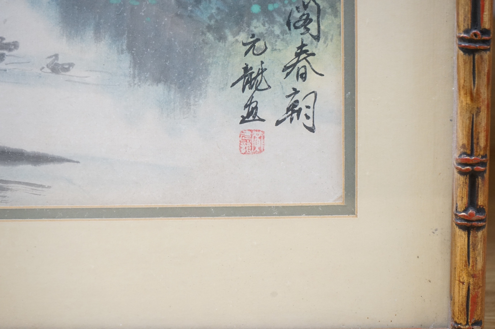 20th century, Chinese School, ink and watercolour, Riverscape with junks, signed with character and red seal marks, 35 x 53cm, housed in a bamboo style frame. Condition - fair